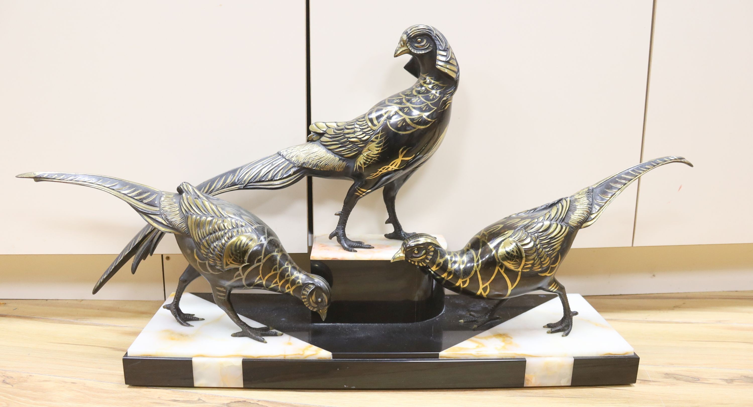 An Art Deco cold painted and gilded spelter model of 3 pheasants on a black and rouge marble base, 89cm